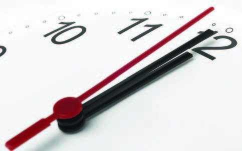 a clock showing almost midnight