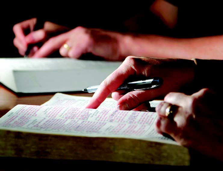 finger pointing at bible scripture