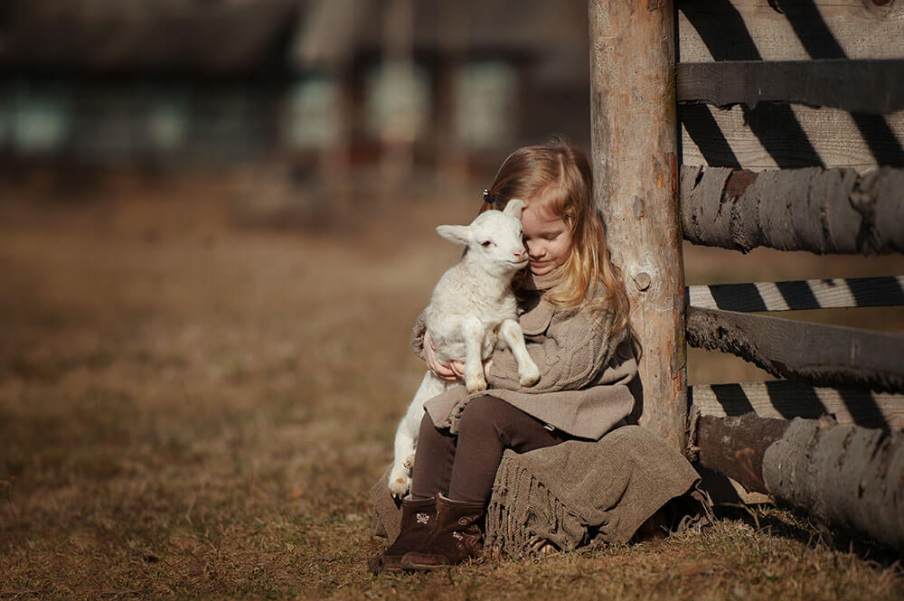girl holding a goat